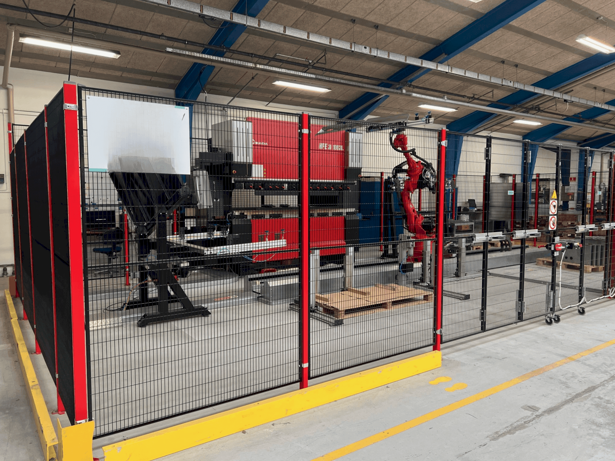 Front view of AMADA HFE3i 1003 8 axes L machine