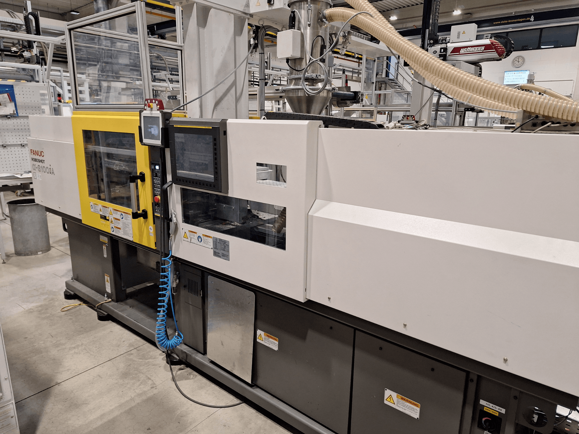 FANUC Roboshot α-S300iA injection molding machine, front view, featuring control panel, and visible industrial components.